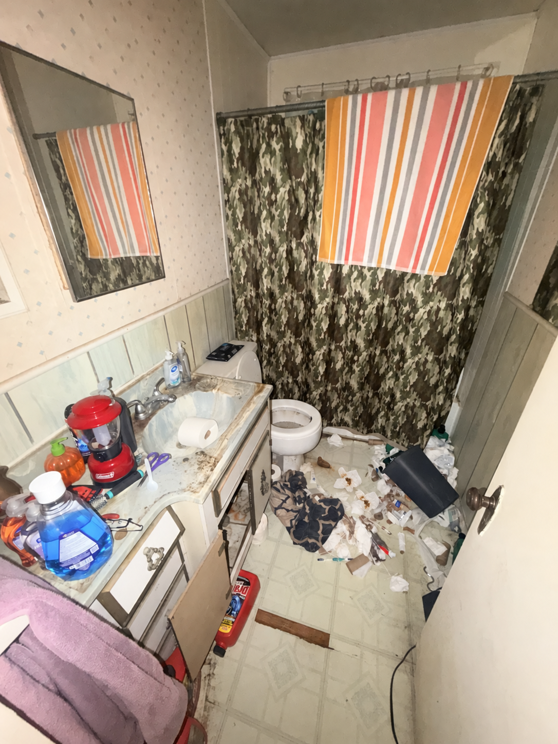 Bathroom floor with waste and debris beside the toilet before cleanup in Maysville Oklahoma